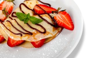 Crepes with strawberries and chocolate sauce